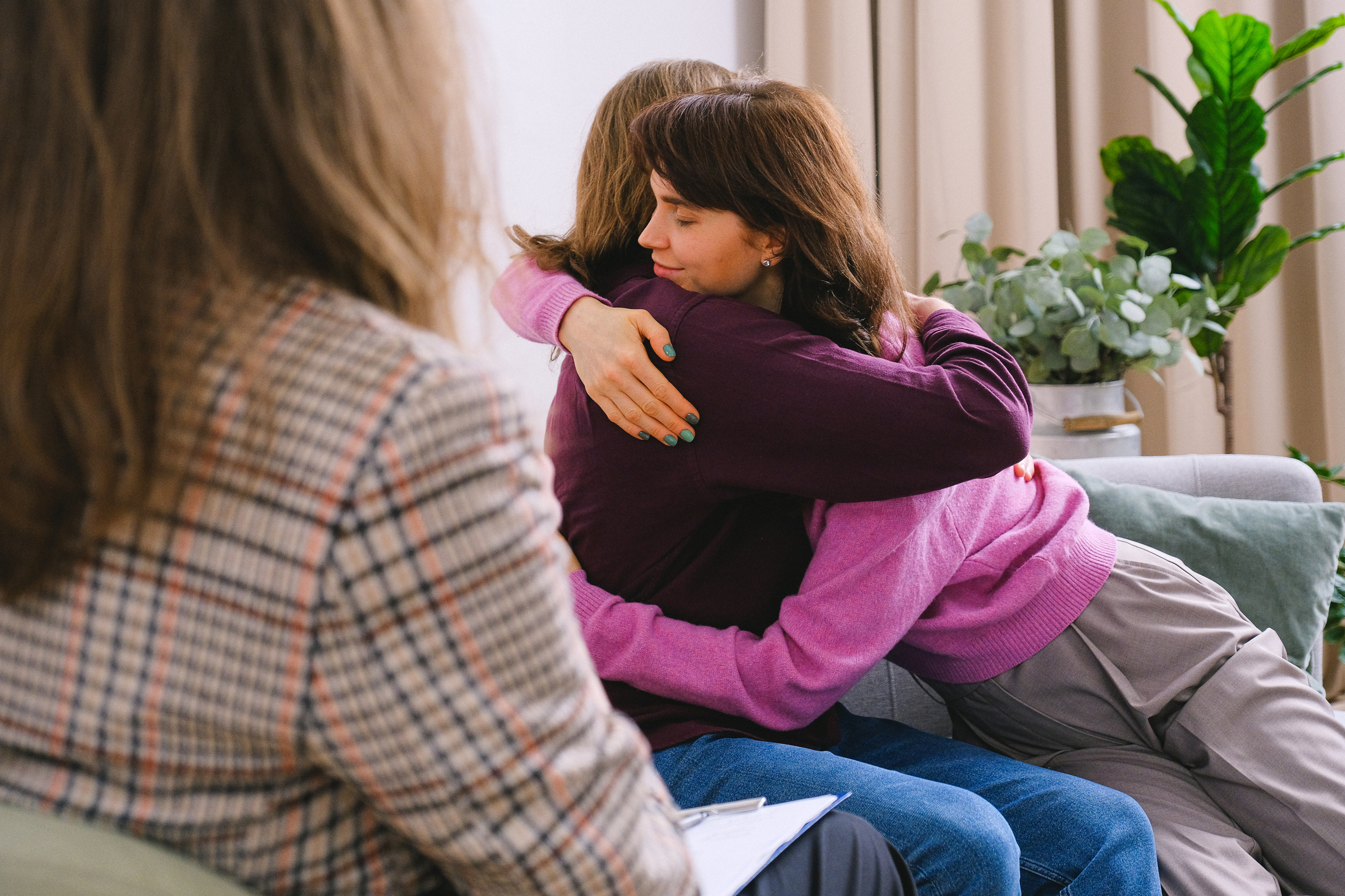 Couple hugging during session with psychologist